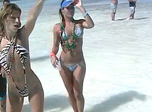 Couple of hot ladys loose their bikini tops on a beach